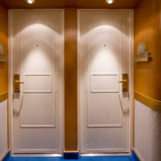 Double doors to fancy cabins on a cruise ship.